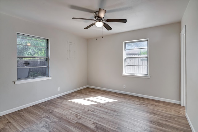 unfurnished room with light wood-type flooring, ceiling fan, and a wealth of natural light