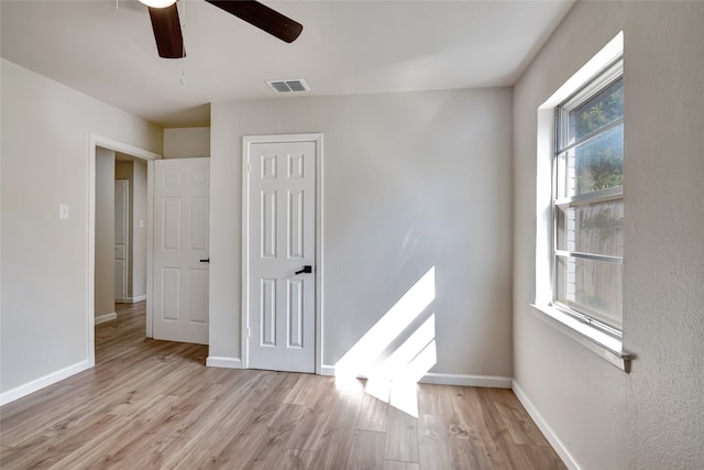 spare room featuring ceiling fan and light wood-type flooring