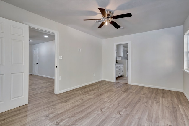 empty room with ceiling fan and light wood-type flooring