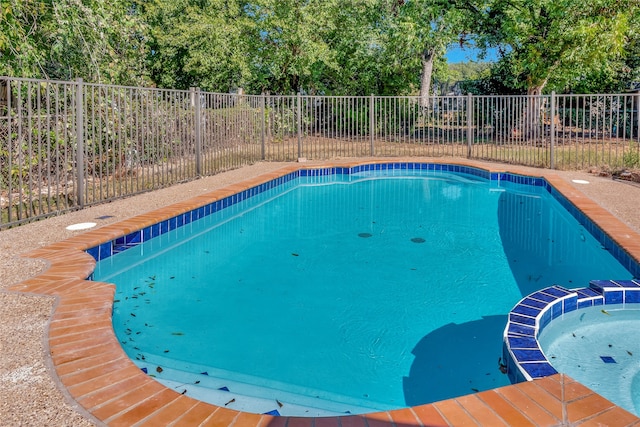 view of pool with an in ground hot tub