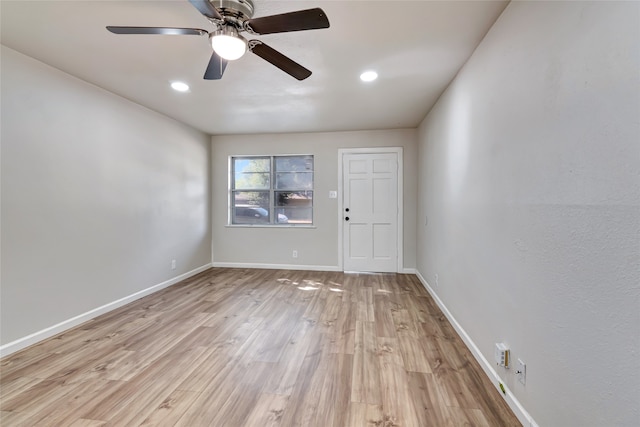 spare room with light wood-type flooring and ceiling fan