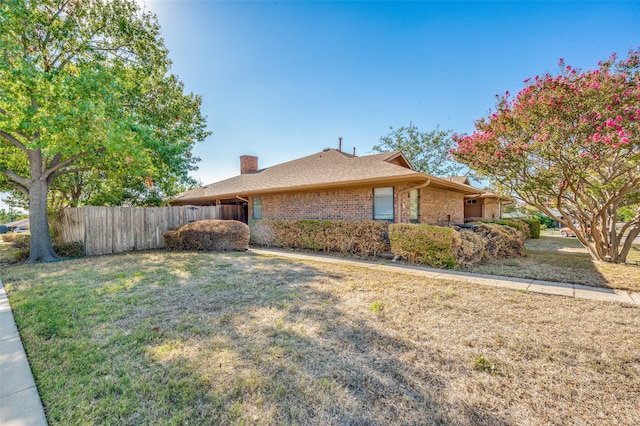 view of side of property with a yard