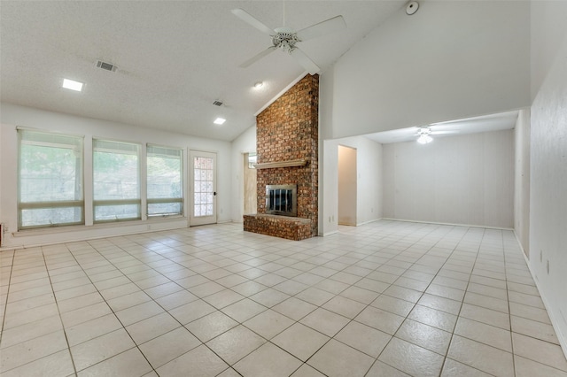 unfurnished living room featuring high vaulted ceiling, a textured ceiling, a fireplace, and light tile patterned flooring