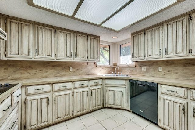 kitchen featuring light tile patterned floors, sink, tasteful backsplash, a textured ceiling, and black dishwasher