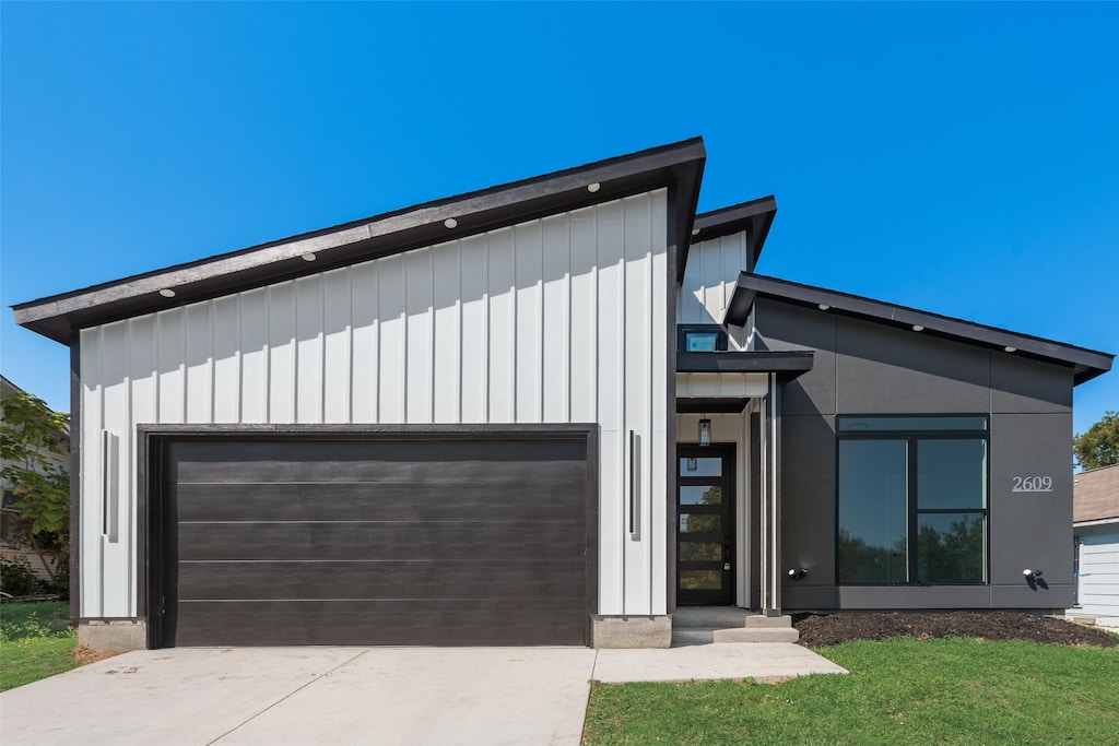 modern home with a garage and a front lawn