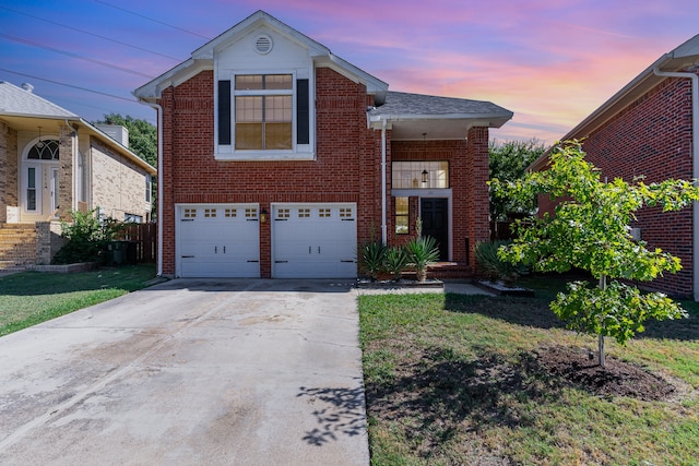 view of front facade with a garage and a lawn