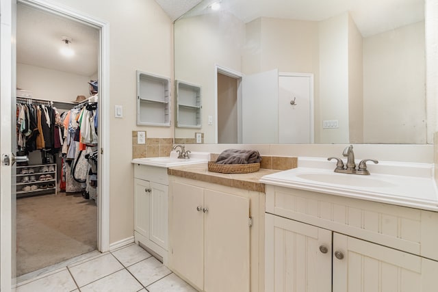 bathroom with vanity, tile patterned flooring, and a textured ceiling