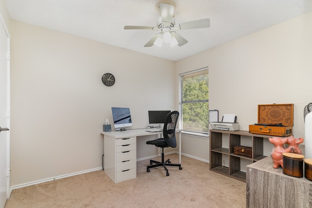 carpeted office with ceiling fan and a textured ceiling