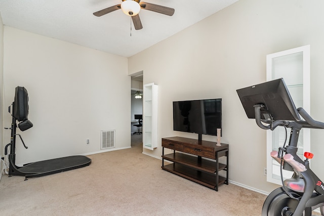 workout area featuring ceiling fan and light colored carpet