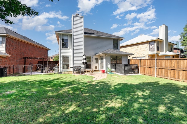 back of house featuring a lawn and a patio