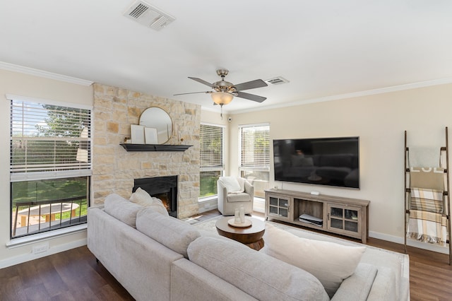 living room featuring ornamental molding, dark wood-type flooring, and a healthy amount of sunlight