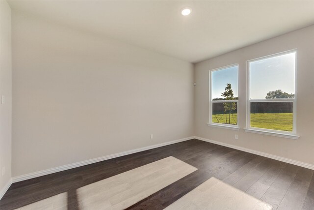 unfurnished room featuring dark hardwood / wood-style floors