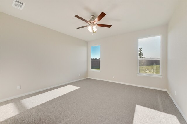 unfurnished room with ceiling fan and carpet floors