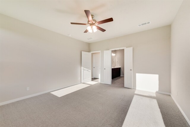 spare room with ceiling fan and light carpet