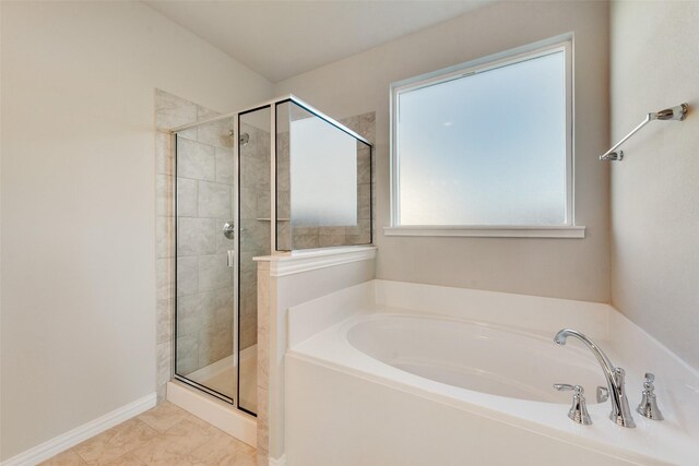 bathroom featuring tile patterned flooring and independent shower and bath