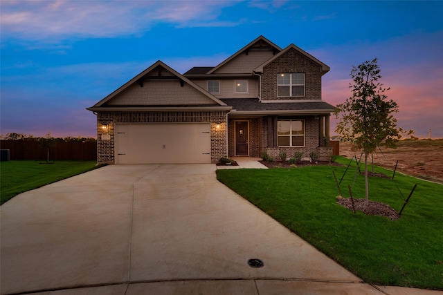 craftsman-style home featuring a lawn and a garage