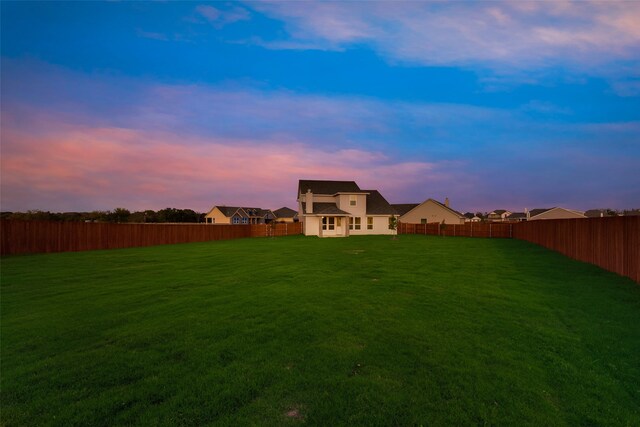 view of yard at dusk