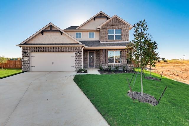 craftsman house featuring a front yard and a garage