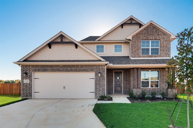 craftsman house with a garage and a front yard