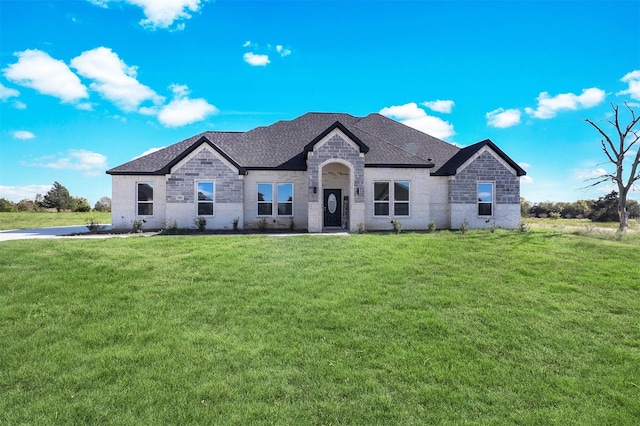 french provincial home featuring a front yard