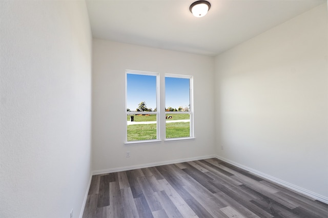 empty room with dark hardwood / wood-style flooring