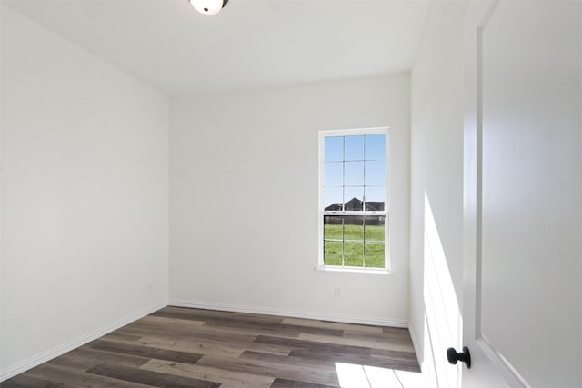 unfurnished room with dark hardwood / wood-style flooring