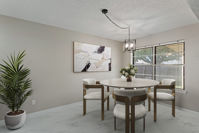 dining room featuring an inviting chandelier and a textured ceiling