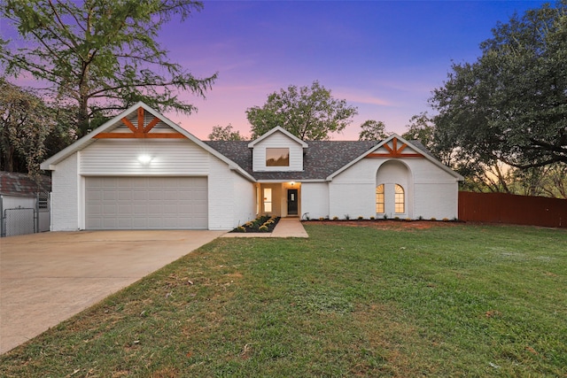 view of front of house with a garage and a lawn