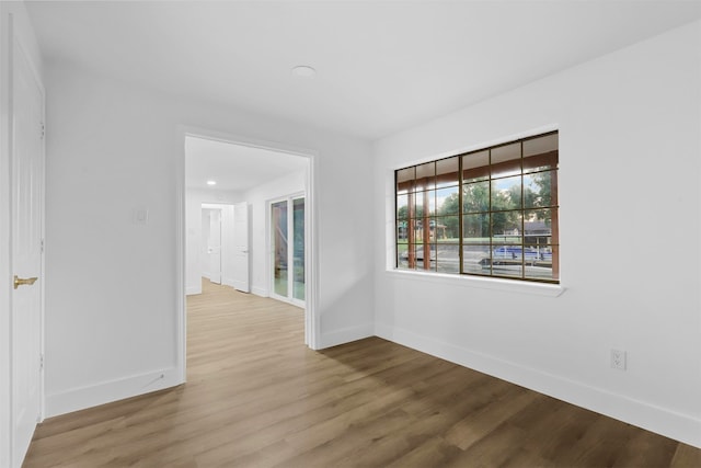 unfurnished room featuring hardwood / wood-style flooring