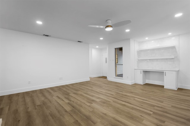 unfurnished living room featuring ceiling fan and light hardwood / wood-style flooring