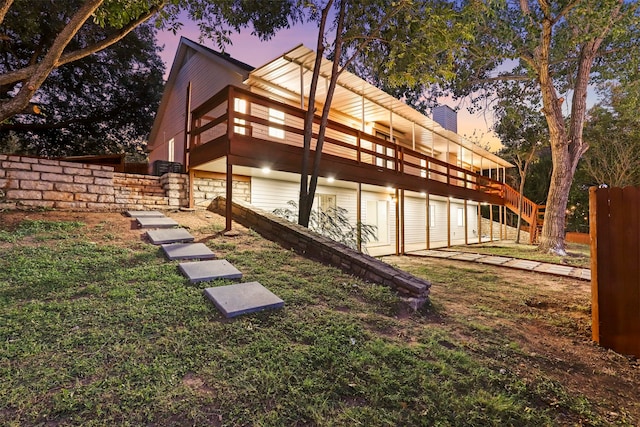 exterior space featuring a lawn and a wooden deck