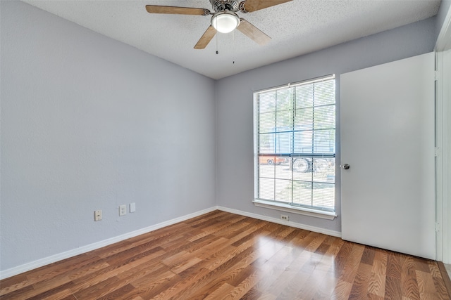 unfurnished room featuring ceiling fan, hardwood / wood-style floors, and a textured ceiling