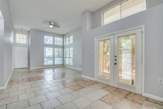 interior space featuring french doors, light tile patterned floors, ceiling fan, and a wealth of natural light