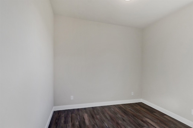 empty room with dark hardwood / wood-style flooring