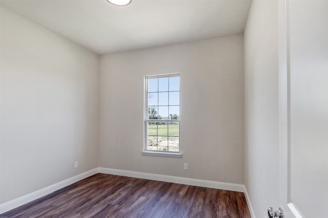 empty room with dark hardwood / wood-style flooring