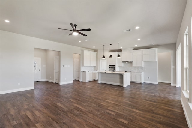 unfurnished living room with ceiling fan and dark hardwood / wood-style floors