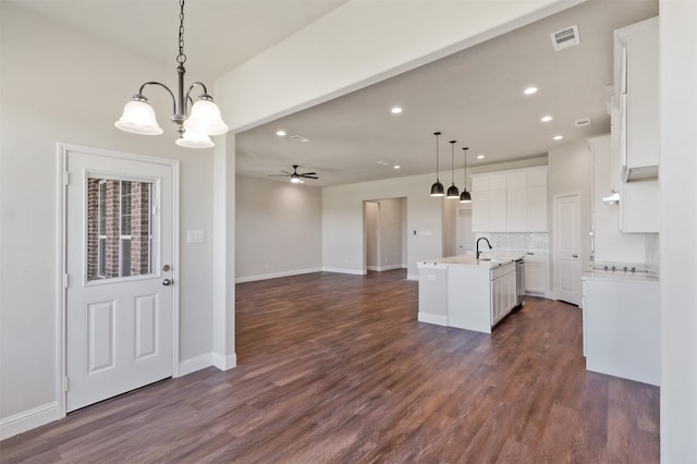 kitchen with a kitchen island with sink, dark hardwood / wood-style flooring, and pendant lighting