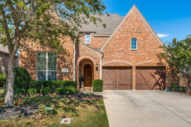 tudor-style house featuring a garage