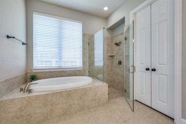 bathroom with plenty of natural light, tile patterned flooring, and independent shower and bath