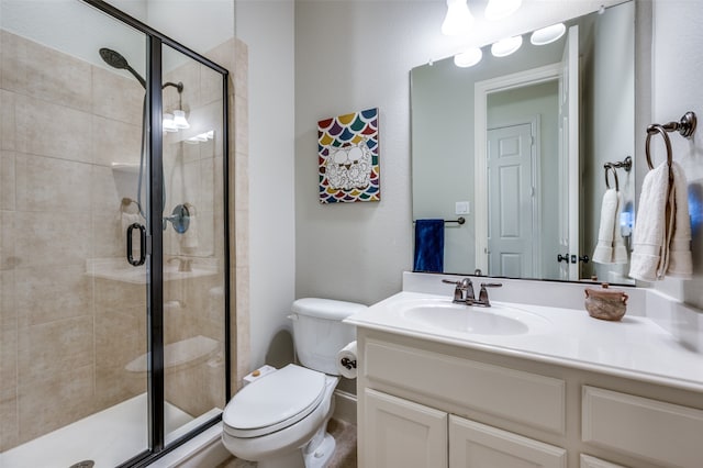 bathroom with walk in shower, vanity, and toilet