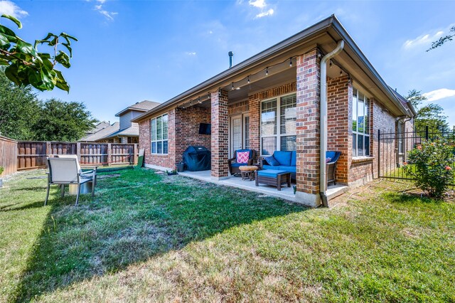 back of property featuring a patio and a lawn