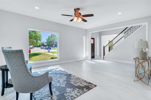 sitting room featuring ceiling fan