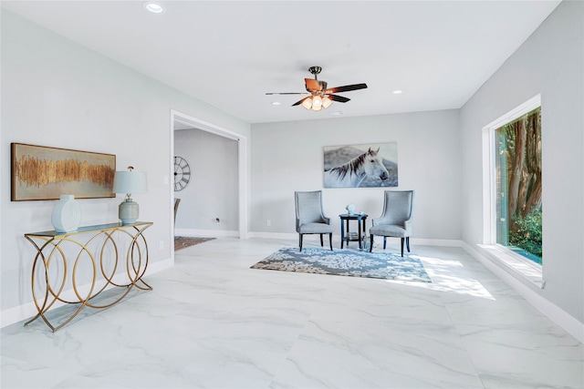 sitting room with ceiling fan