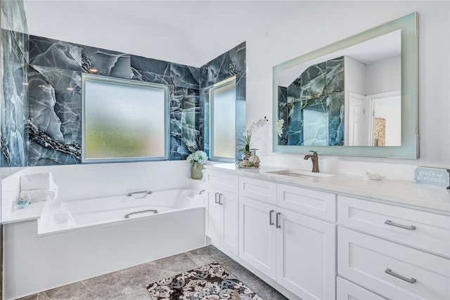 bathroom featuring a washtub and vanity