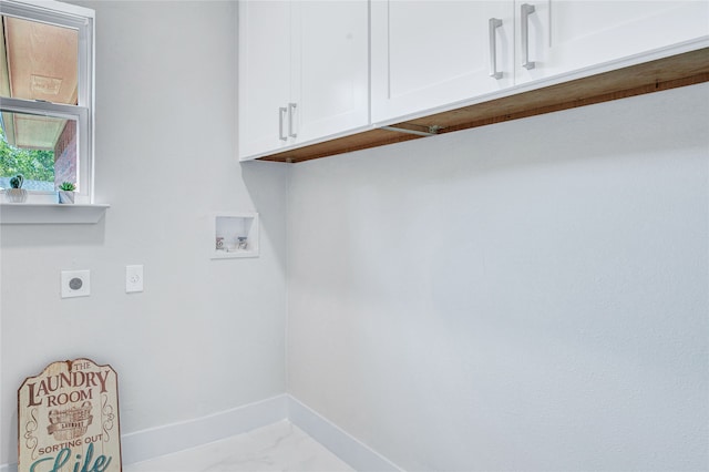 clothes washing area featuring cabinets, electric dryer hookup, and hookup for a washing machine