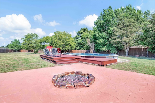 view of patio / terrace with a swimming pool side deck and an outdoor fire pit