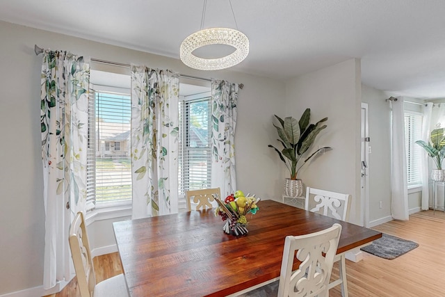 dining area with light hardwood / wood-style flooring and a wealth of natural light