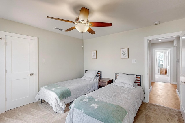 bedroom with light wood-type flooring and ceiling fan