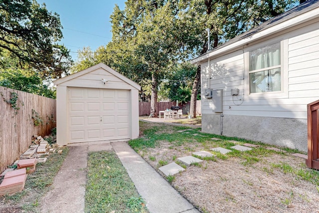 view of yard featuring a patio area, an outdoor structure, and a garage