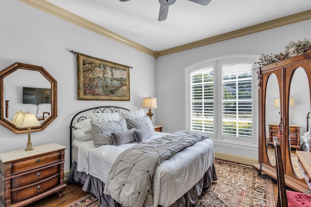 bedroom featuring crown molding, ceiling fan, and dark hardwood / wood-style floors